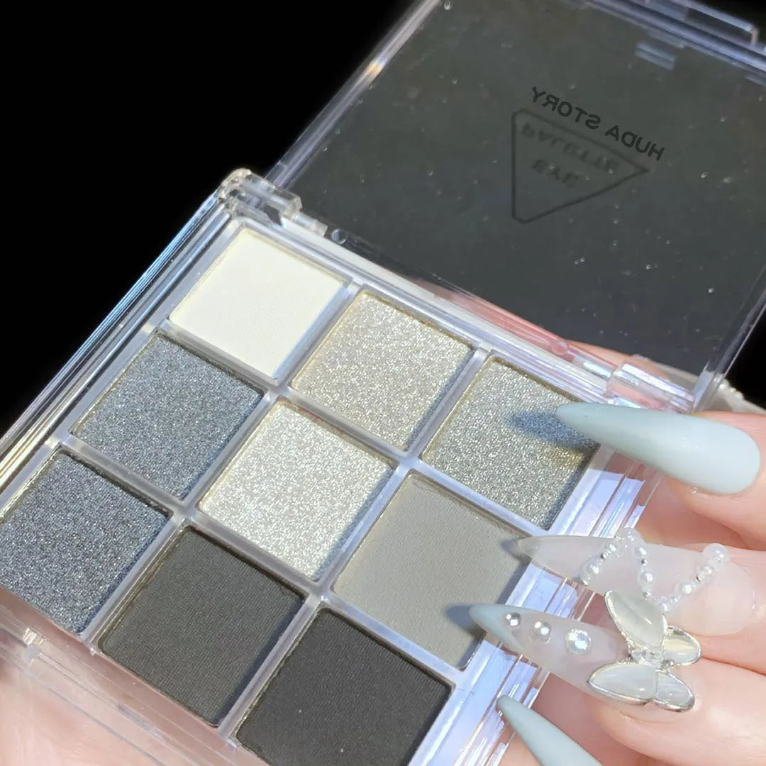 Smoked design nine colour eyeshadow palette open showing white, silver, black, iron grey shades.