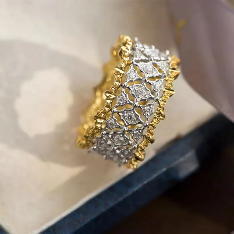 Geometric two-tone gold zircon ring on a copper band, showing round design elements.