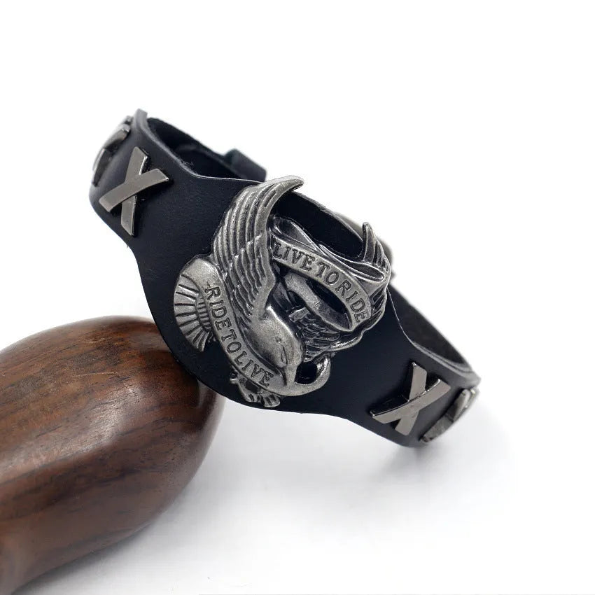 Black geometric eagle head leather bracelet with tapered width and button fastening.