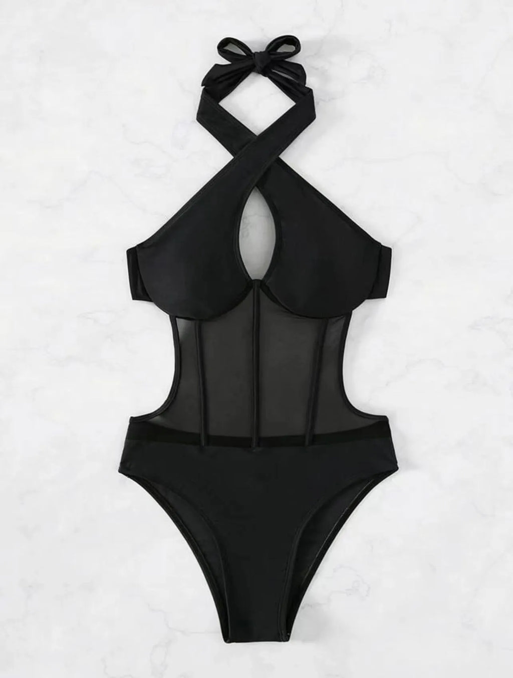 A black ladies one-piece swimsuit bikini made from nylon and spandex fabric on a neutral background.