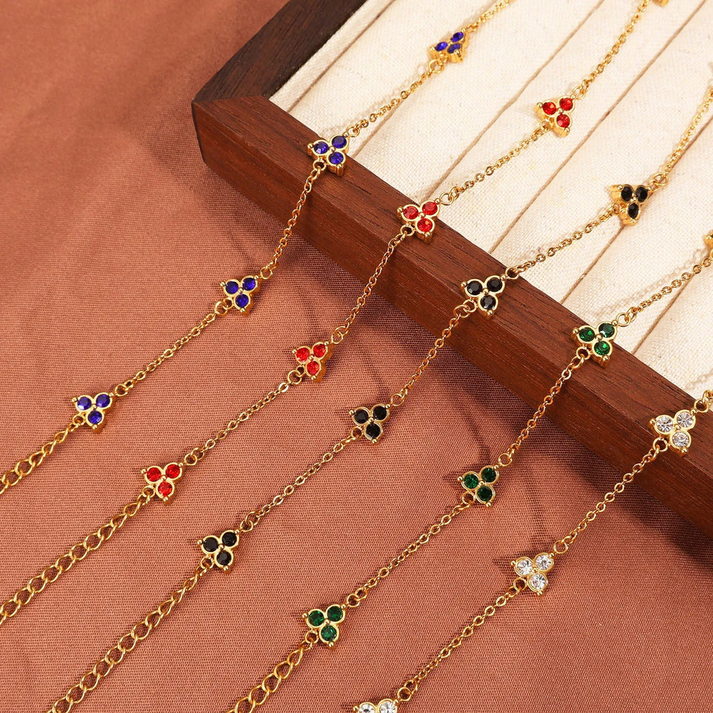 Women's stainless steel geometric bracelet with triangle details and a coloured stone setting.