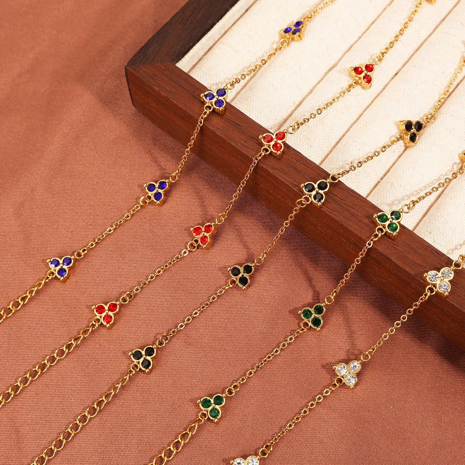 Women's stainless steel geometric bracelet with triangle details and a coloured stone setting.