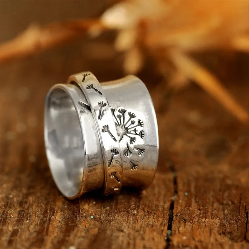 Silver rotatable flower ring showing adjustable floral element on finger