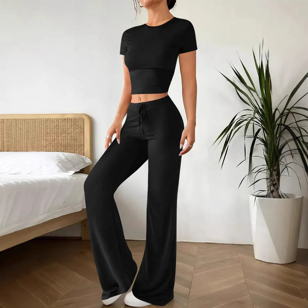 Black women's co-ord suit with high-waist trousers and a short-sleeve T-shirt on a hanger.