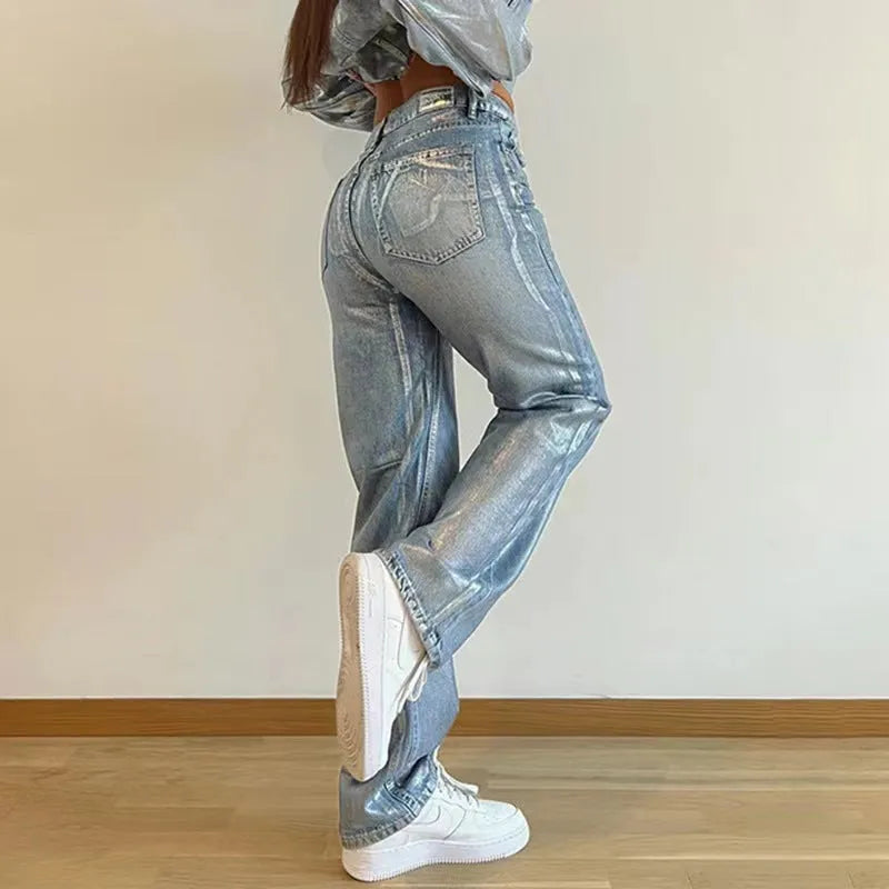 Blue high-waist straight-leg women's jeans with contrast colour detailing on a denim background.