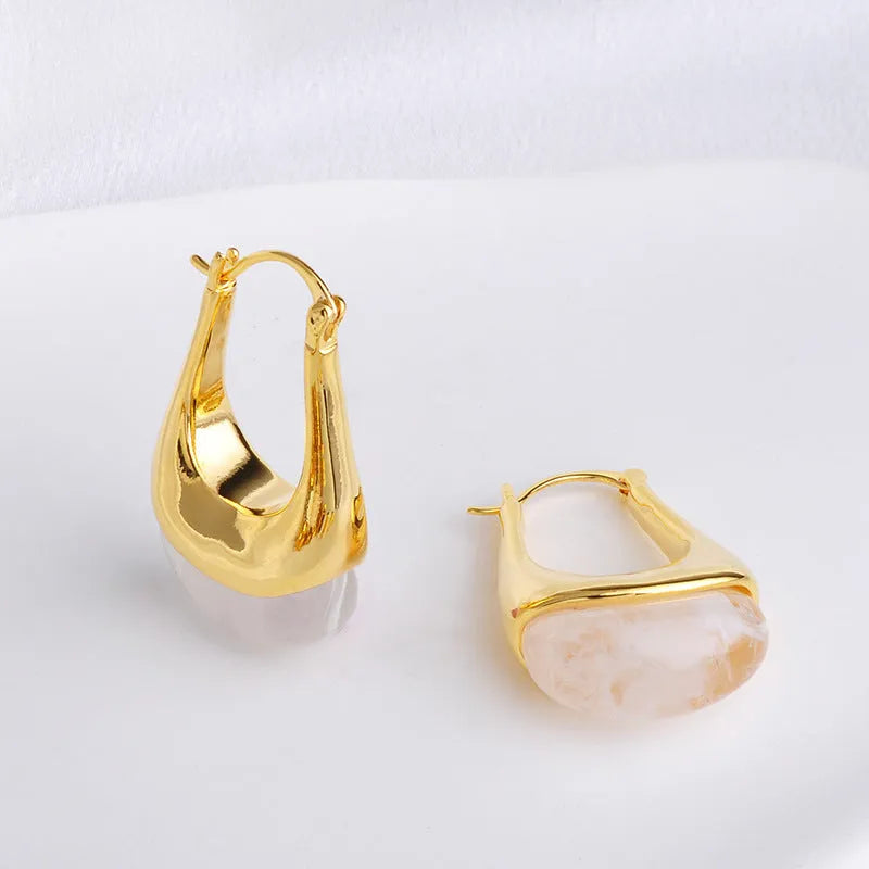 Copper geometry shape retro Maillard style earrings with electroplated finish in amber colour option on plain background