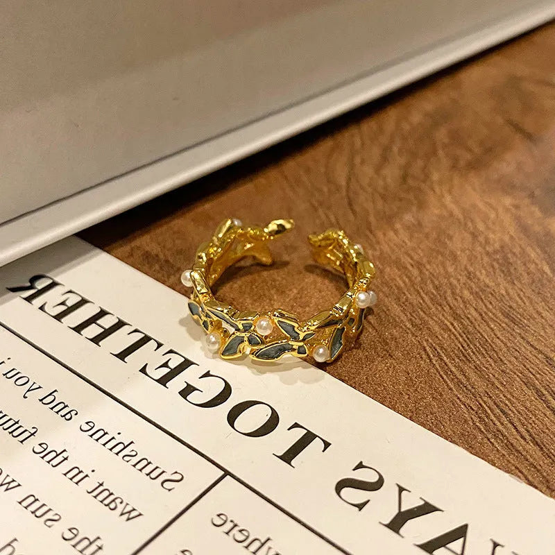 Copper butterfly women's ring with oil-drip finish showing open-loop design