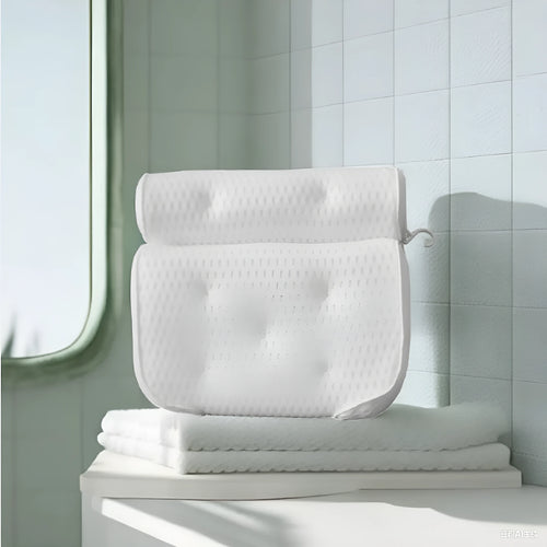 White bathtub pillow with 4D mesh fabric and seven large suction cups on a flat surface.