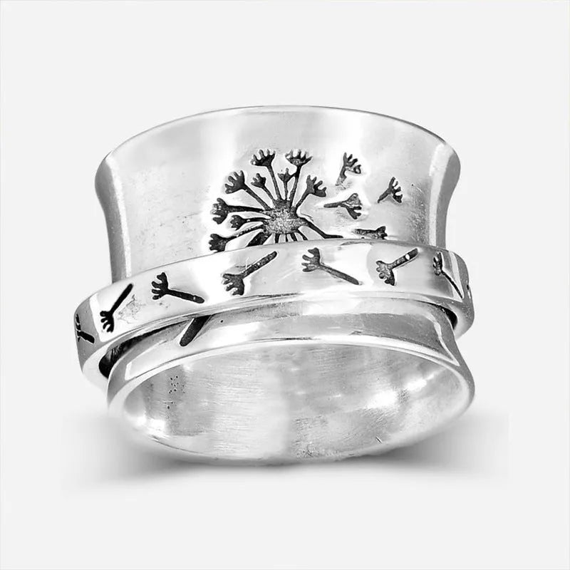 Silver rotatable flower ring showing adjustable floral element on finger