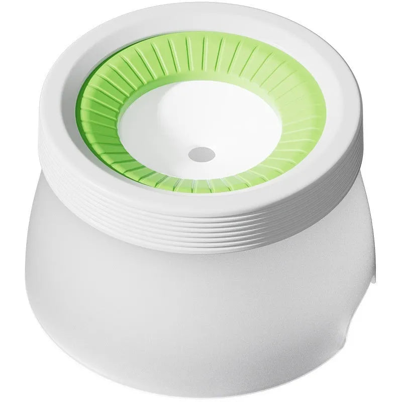 Green suspended pet water bowl for medium and small dogs and cats on a white plate