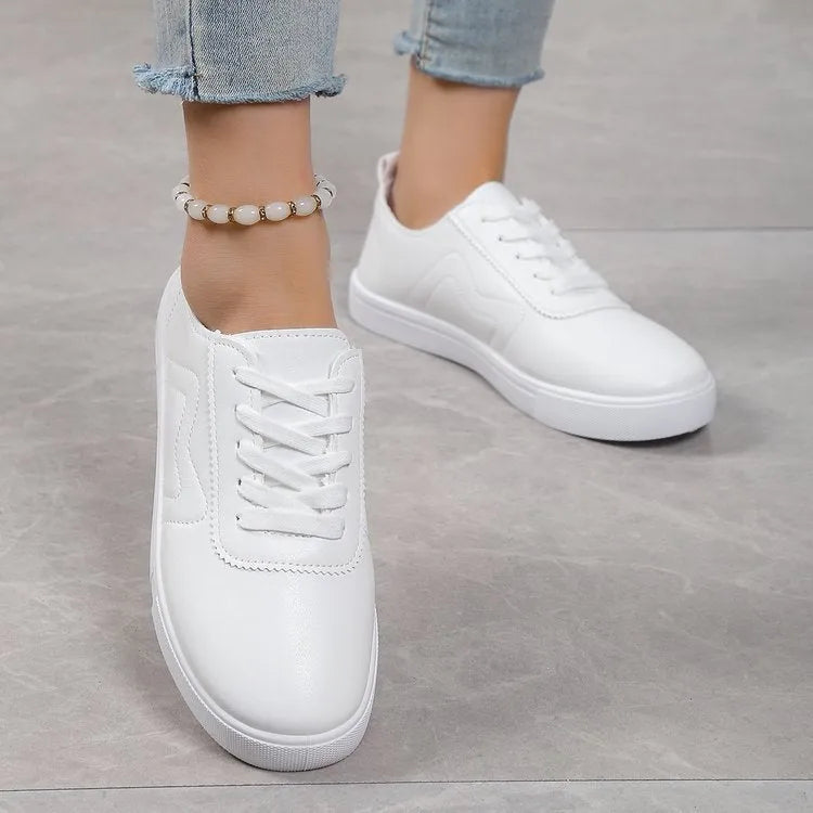 White round toe lace up casual shoes with platform heel on a flat surface