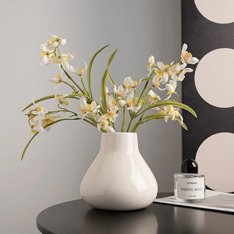 Ceramic decorative vase with artificial flowers in black or white modern design