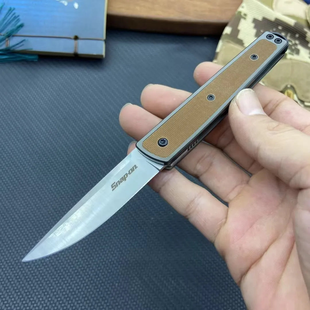 Closed and open views of a folding fruit knife with stainless steel blade in black, brown, or red handle options.