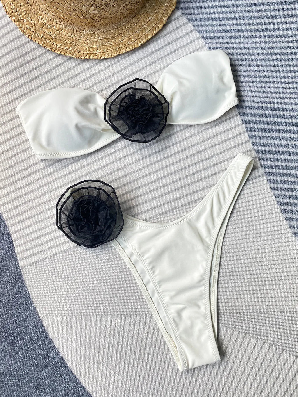 Black and white striped bikini with cross-back tube top and floral split detail on the shorts.