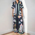 Black women's casual set with cartoon print, featuring a long-sleeve cardigan and trousers.