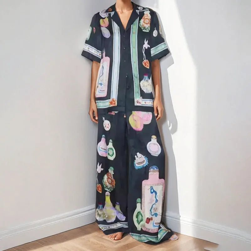 Black women's casual set with cartoon print, featuring a long-sleeve cardigan and trousers.