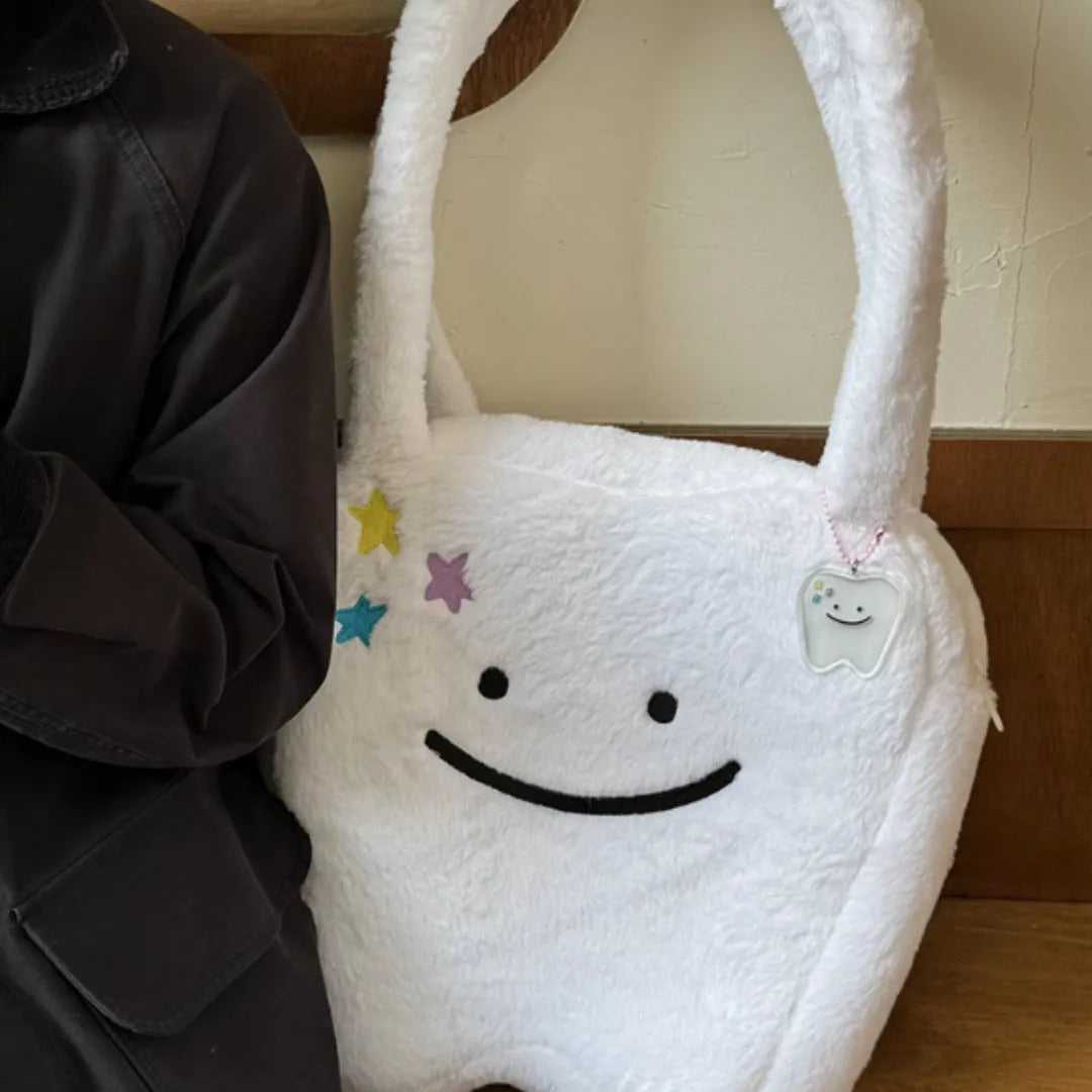 White plush shoulder tote bag with a large capacity and playful cute teeth design, shown with a crossbody strap.