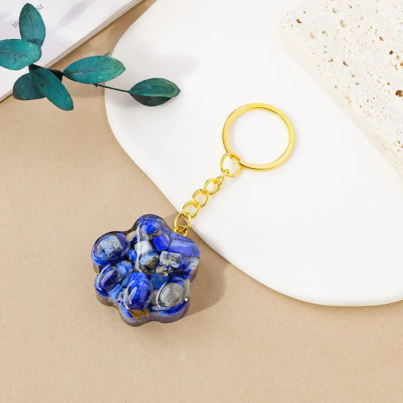 Small natural crystal cat's paw claw charm on a metal loop keychain