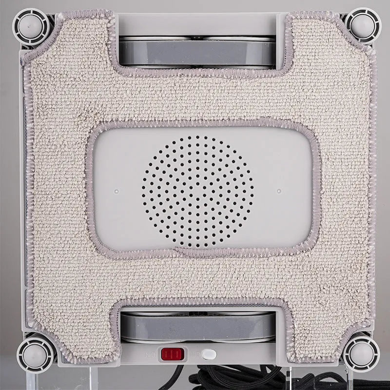 White intelligent window cleaning robot with compact design on a window pane
