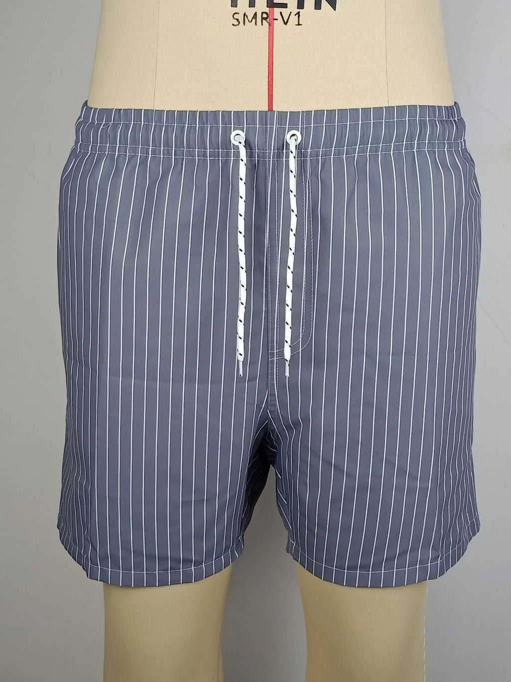 Men's striped polyester beach shorts in light blue with straight leg cut
