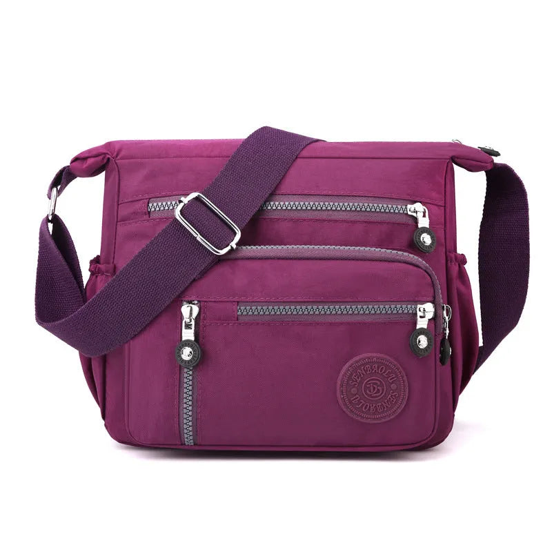 Grey lightweight nylon messenger bag with large capacity and single shoulder strap.