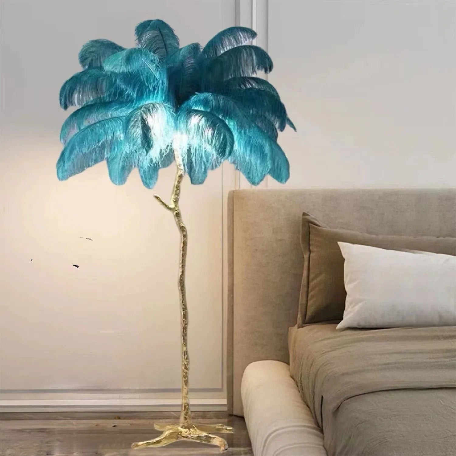 Tall decorative floor lamp with many white resin feathers, standing in a living room corner.