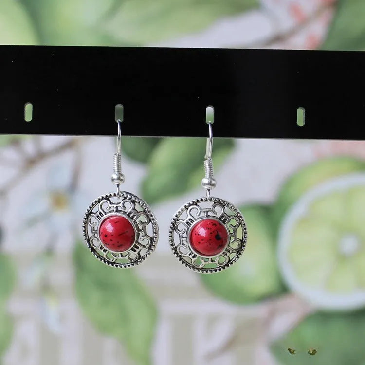 Miao ethnic silver earrings with geometric flower disk design and turquoise accents