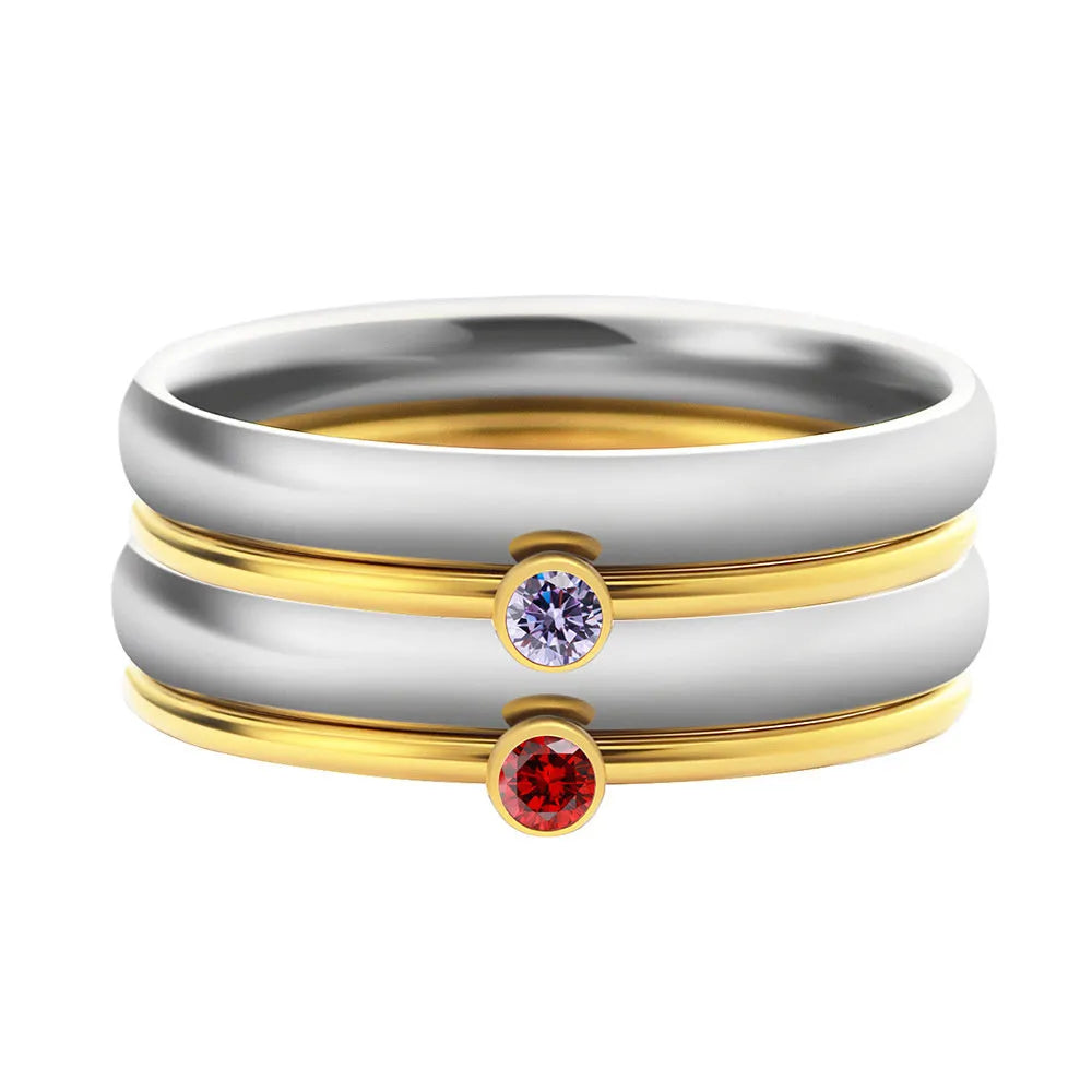 Geometric titanium steel ring with engraved December birthstone design on a finger.