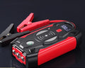 Red car emergency jump starter with digital display and battery clips showing 39800A peak current