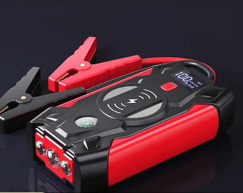 Red car emergency jump starter with digital display and battery clips showing 39800A peak current