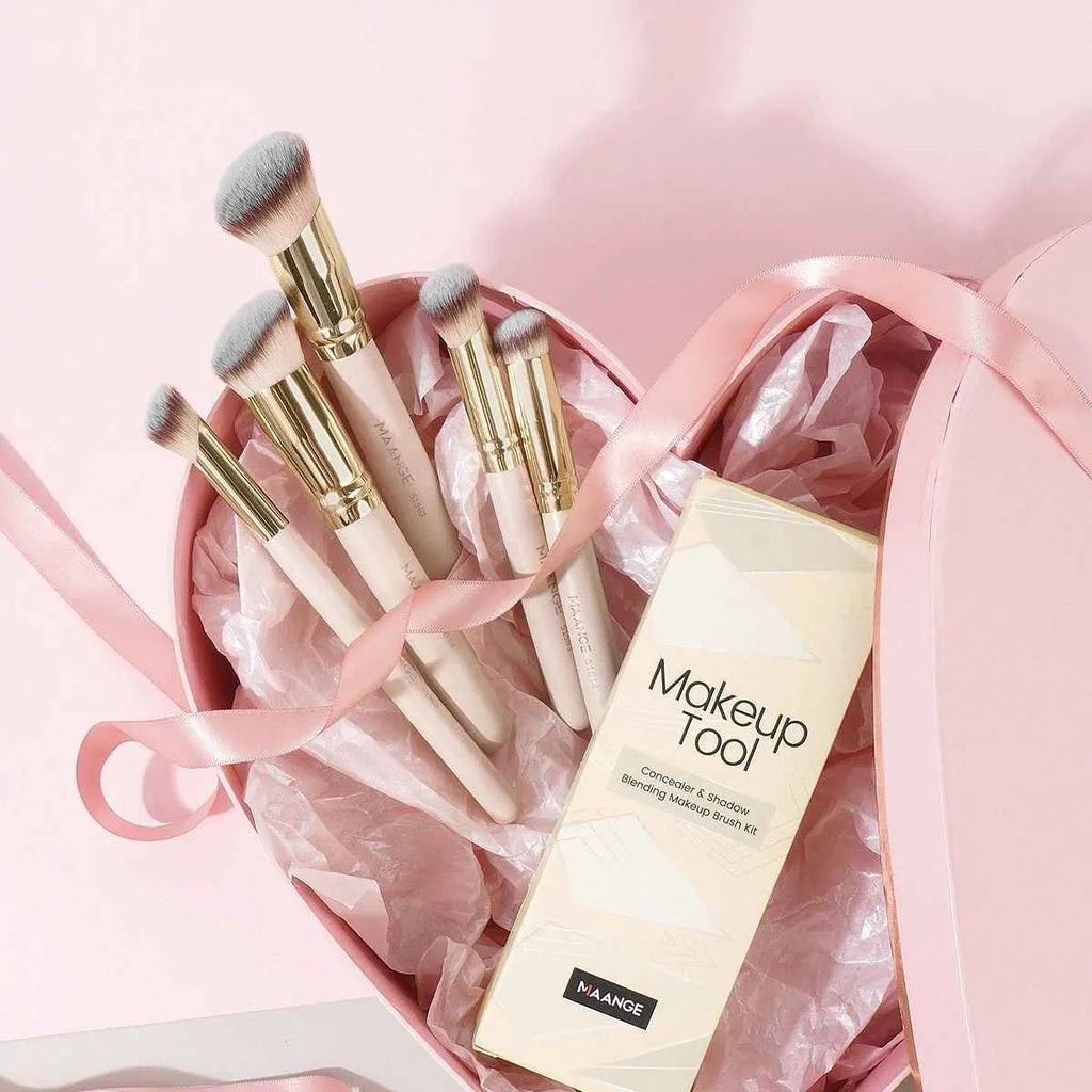 Five apricot coloured makeup brushes including angled blush brush for contouring