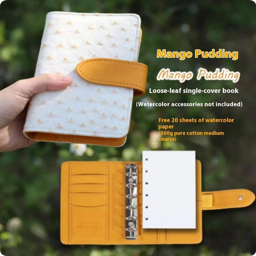 A7 format loose-leaf watercolour notebook in green, open to show removable pages suitable for painting.
