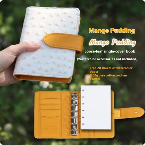 A7 format loose-leaf watercolour notebook in green, open to show removable pages suitable for painting.