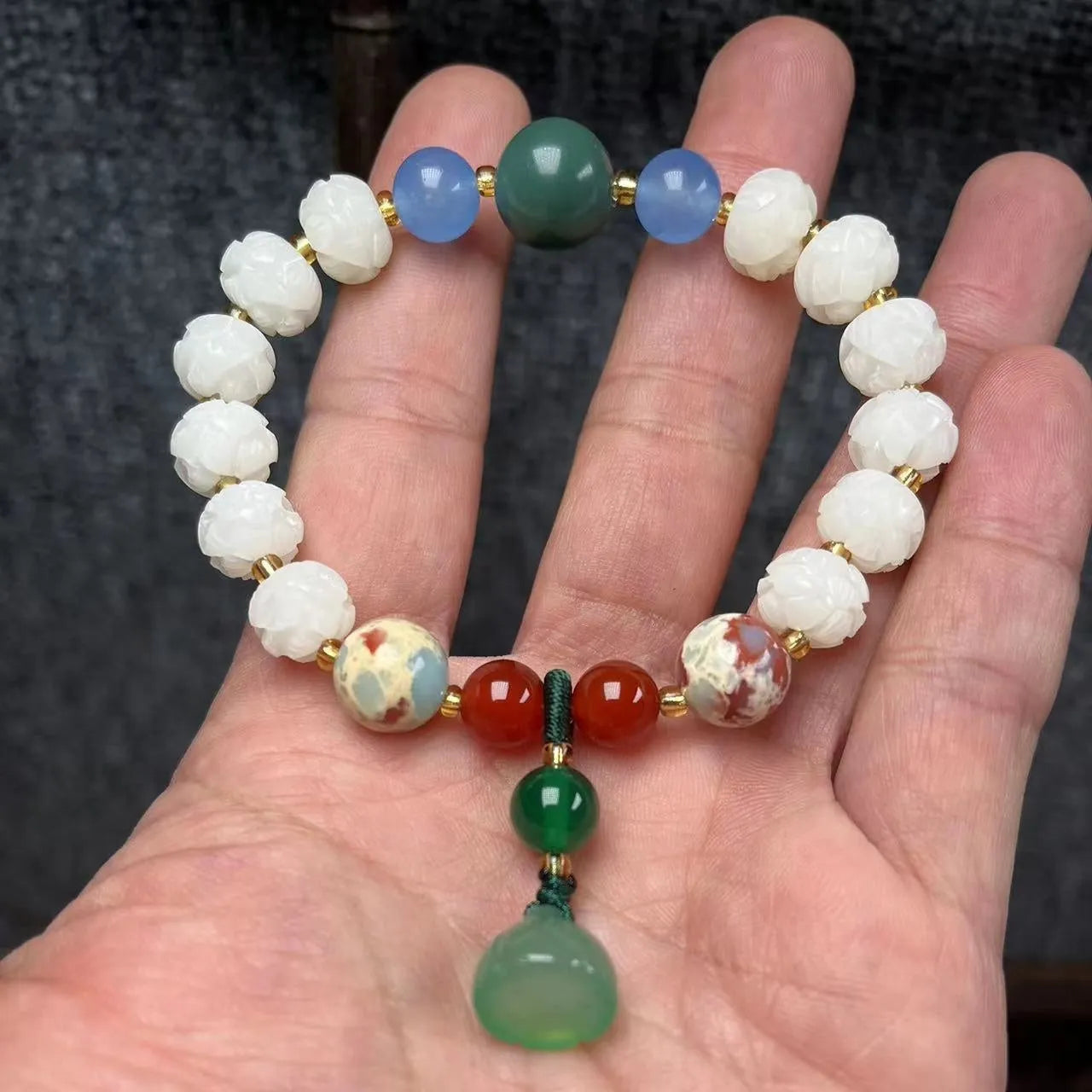 Carved Bodhi root bracelet with white jade, lotus, and pumpkin beads in various sizes.