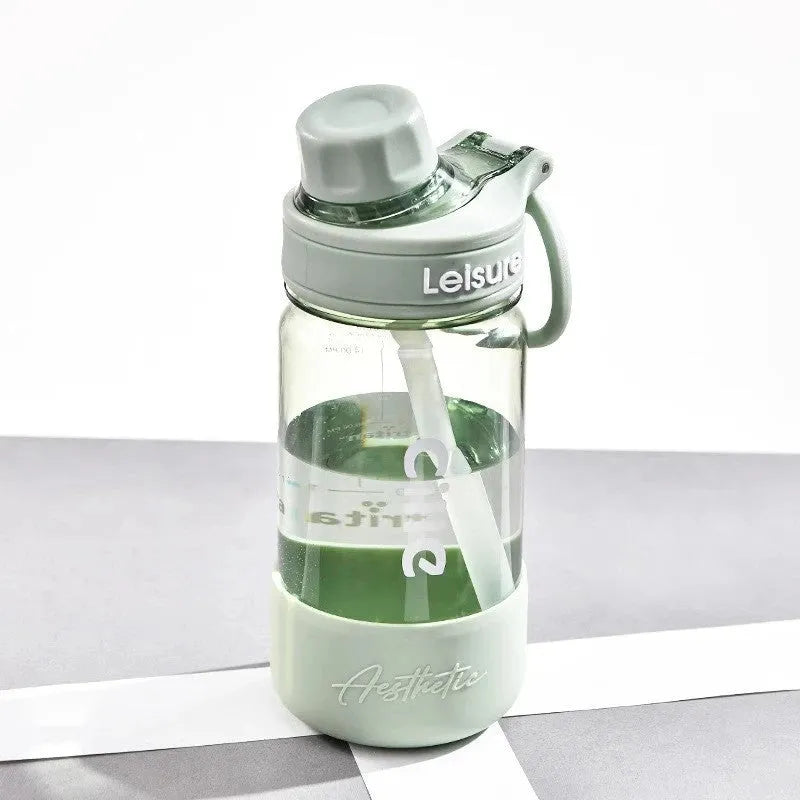 Cartoon pattern plastic straw cup in grey, green, or pink, showing heat-resistant and portable design.