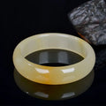 A polished light jade bracelet for women, shown in a Chinese style, with size options from 54mm to 62mm.