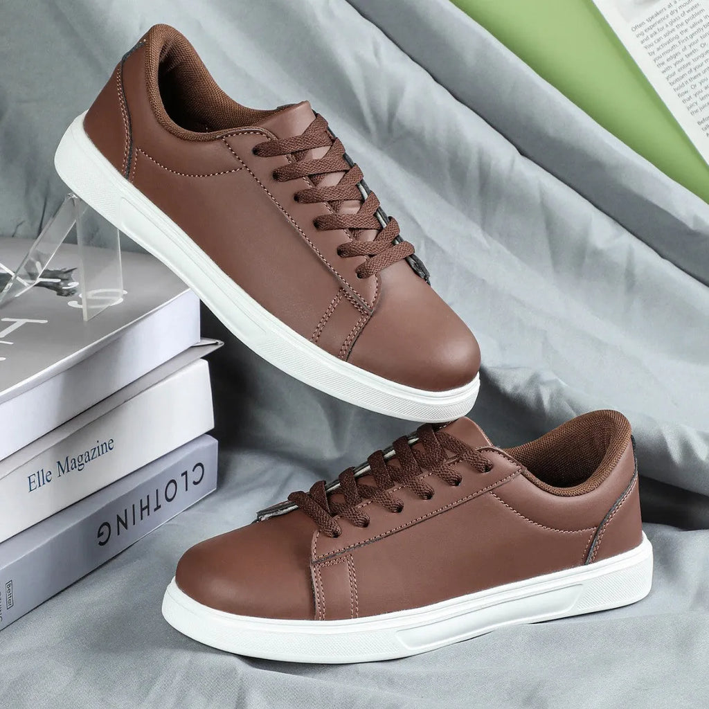 Casual beige brown platform sneakers with a cross strap and round toe on a flat rubber sole.