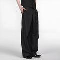 Black straight-leg Tencel cotton trousers with a single pleat and adjustable waistband on a hanger.