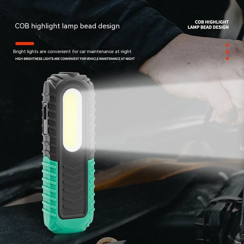 Black and green auto repair work light with USB charging port and clear lens