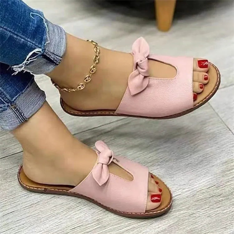 Ladies fish mouth style sandals with a decorative bow on the artificial PU upper, shown in black.