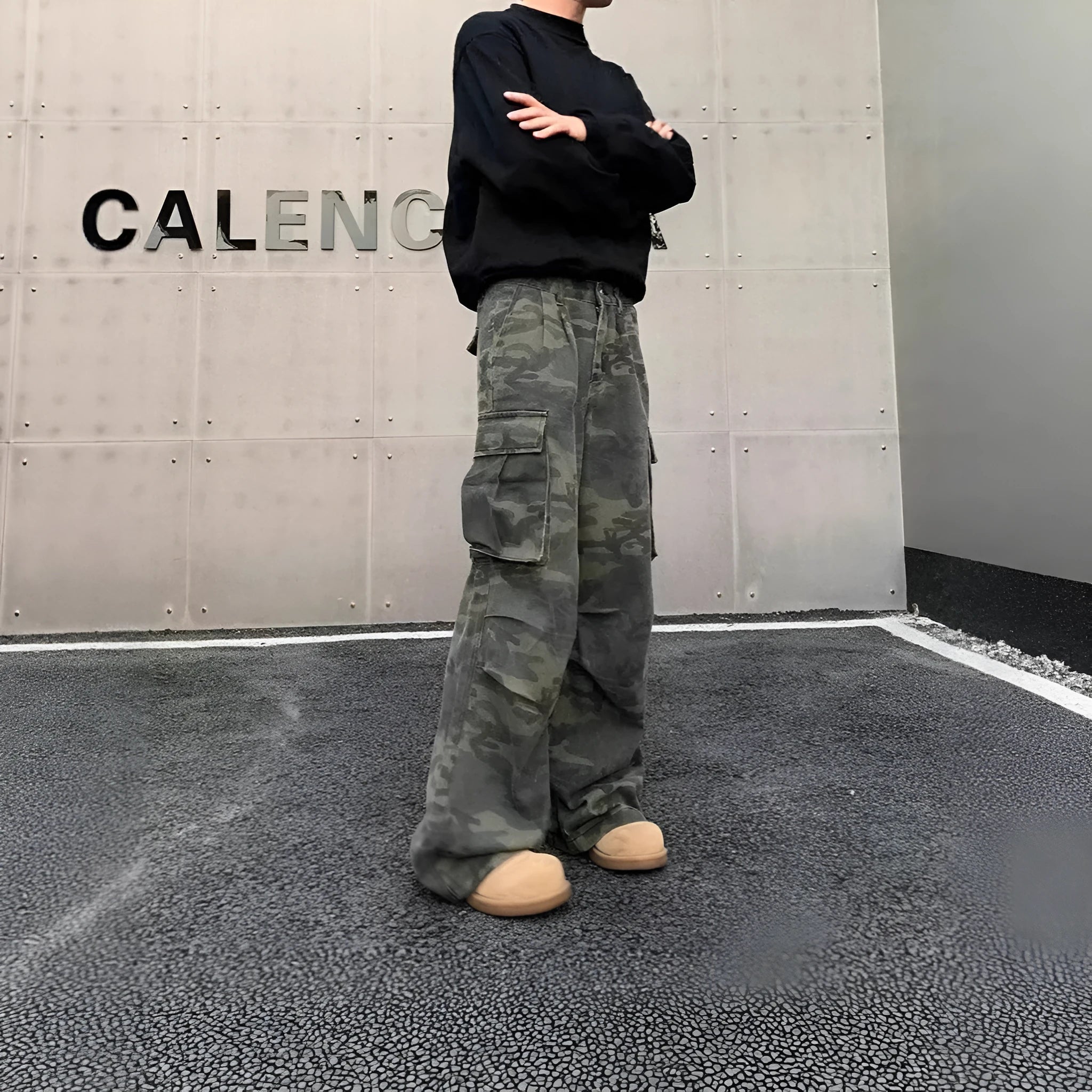 Korean style washed camouflage cargo trousers on a hanger, showing multiple pockets and mid waist design.