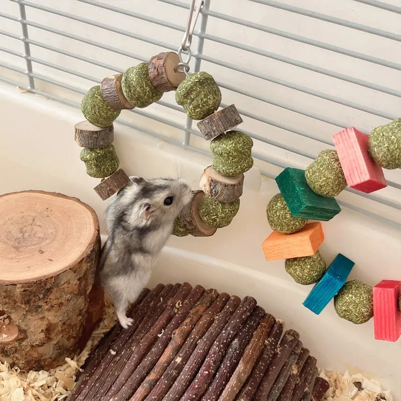 Hamster chew toy with straw ball and applewood ring components for small pets