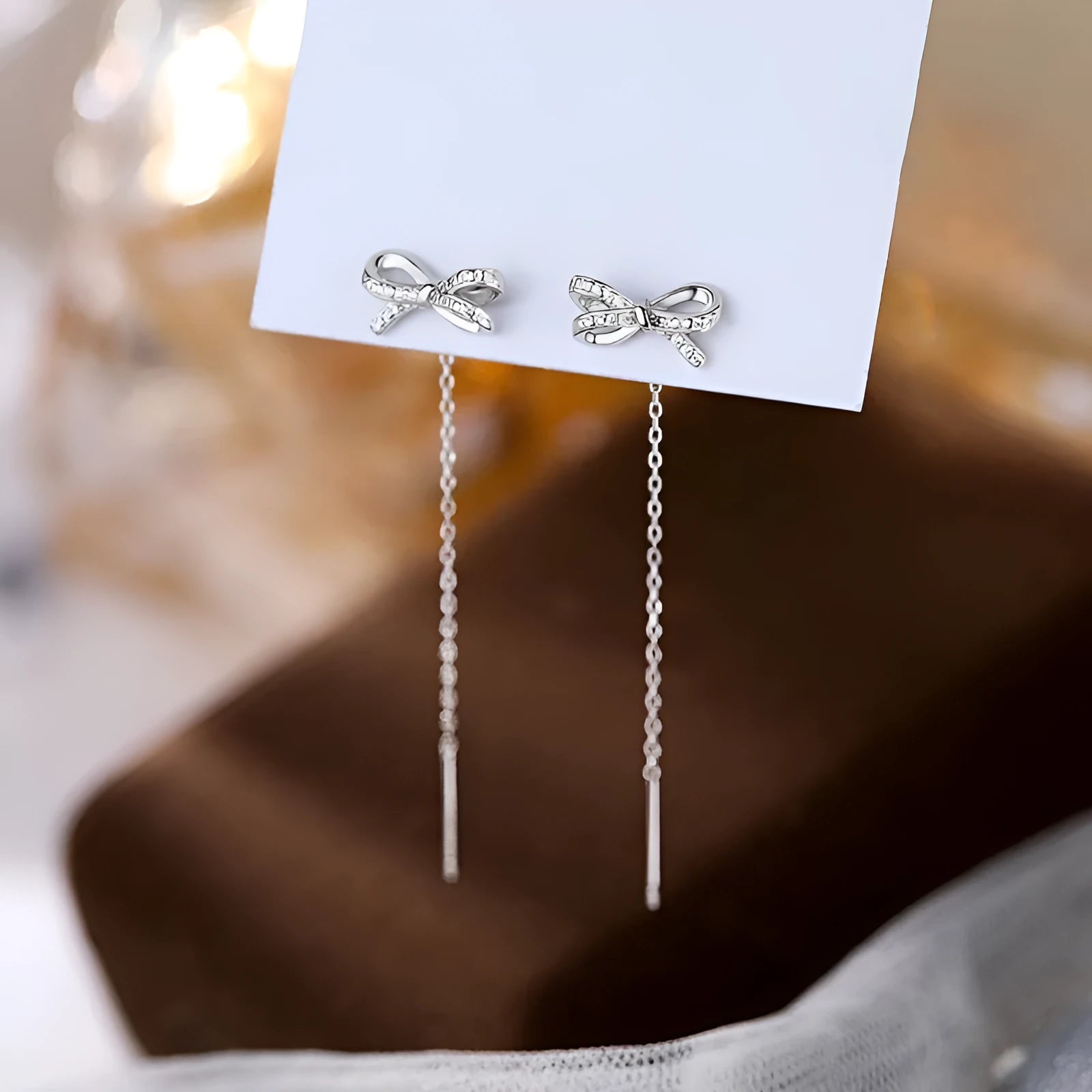 Women's white K bow earrings with long tassel ear thread, copper construction