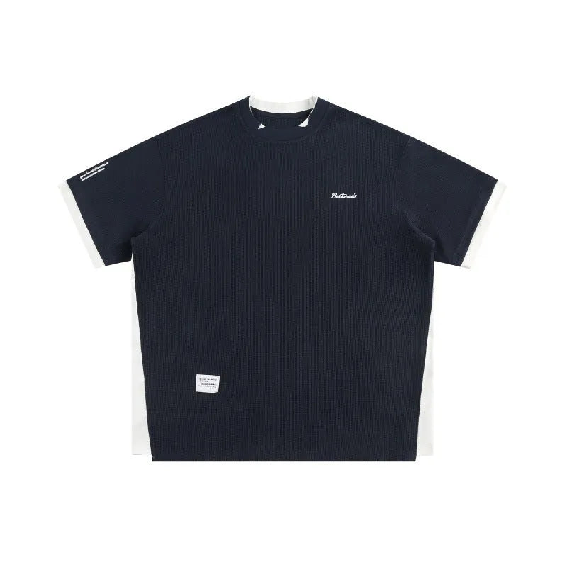 Retro alphabet embroidered loose waffle knit t-shirt in a fake two-piece style, shown in navy blue.