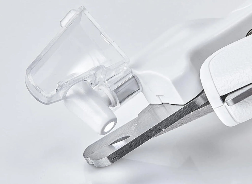 White LED pet nail clipper with a triangular blade, anti-splash guard, and leatherette handle.