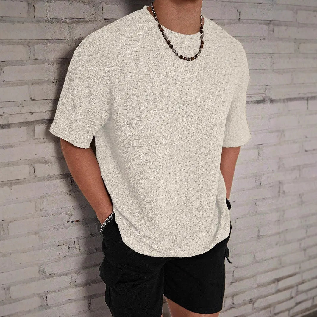 Men's slim fit solid colour T-shirt in light blue, showing round neck and short sleeves