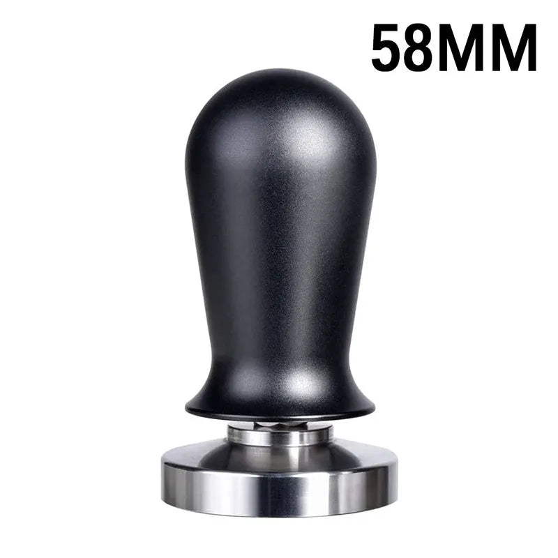 Black silicone pad coffee tamper with stainless steel base next to a red version on a counter.