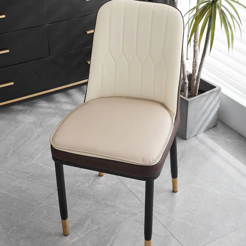 Leather horseshoe-shaped seat cushion in beige colour on a wooden chair, showing non-slip base.