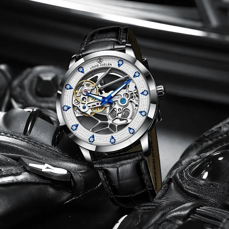 Men's silver case mechanical watch with white dial, blue hands, black leather strap, and stainless steel buckle