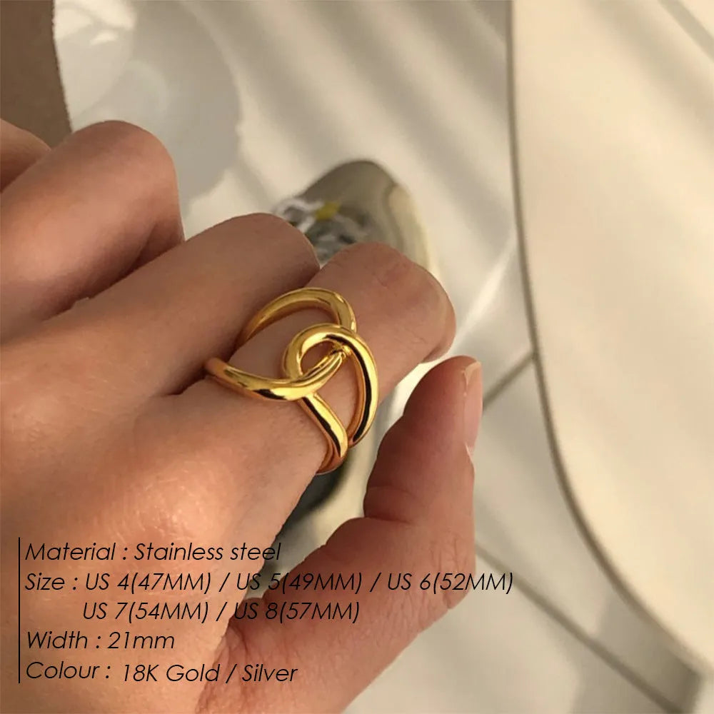 Adjustable geometric ring with knotted design in stainless steel showing U-shaped form and opening mechanism